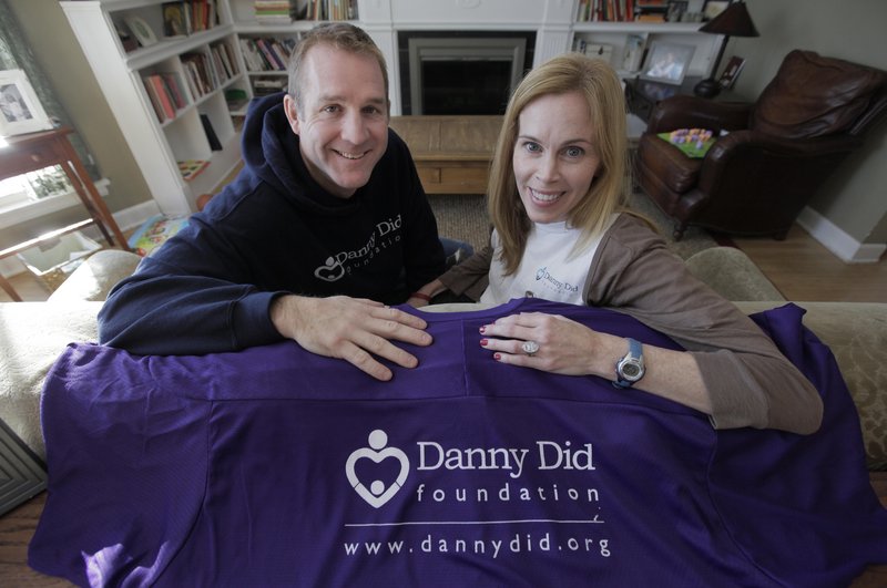 Michael and Mariann Stanton sit in their Chicago home Dec. 8 with items from the foundation they created in memory of their son Danny. Since the 4-year-old’s death from an epileptic seizure last year, they’ve worked to raise awareness of a rare condition called Sudden Unexplained Death in Epilepsy and raised thousands of dollars for specialized monitors.
