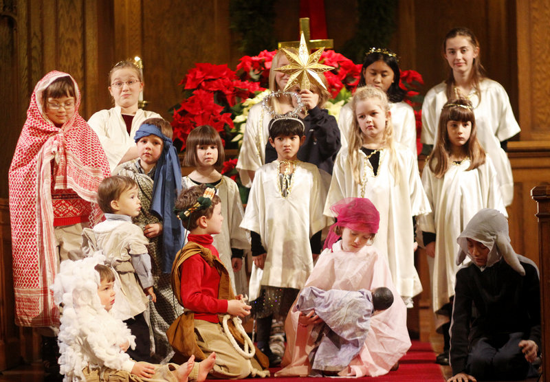 Eight-year-old Sarah Thayer of Portland holds the baby Jesus while playing Mary in the Nativity scene at the Christmas Eve service at Immanuel Baptist Church in Portland.