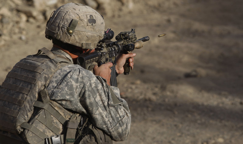 Sgt. Benjamin Olivarez of Kingsville, Texas, a member of the 2nd Platoon Bravo Company 2-327 Infantry, tests his weapon Thursday in eastern Afghanistan. A troop surge to roll back the Taliban has resulted in more U.S. combat deaths.