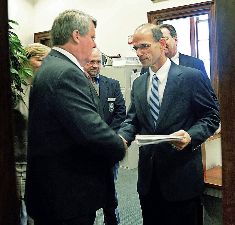 Sen. Dennis Damon, D-Trenton, left, hands Gov. John Baldacci the bill that the Maine Senate passed earlier that day in May 2009 to affirm the right for same-sex couples to marry. Baldacci signed the bill into law that day.