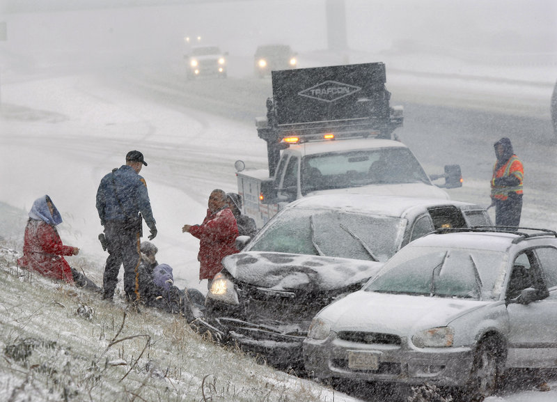A New Jersey state trooper arrives to assist people after their cars collided in a heavy snowfall Sunday on Interstate 295 near Columbus, N.J.