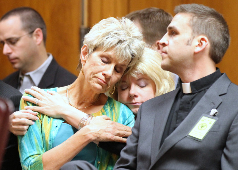 Jeanne Tiller, widow of slain abortion doctor George Tiller, receives a hug from a family member during Scott Roeder’s sentencing. A federal probe seems to be focusing on a Bible study group that Roeder attended.
