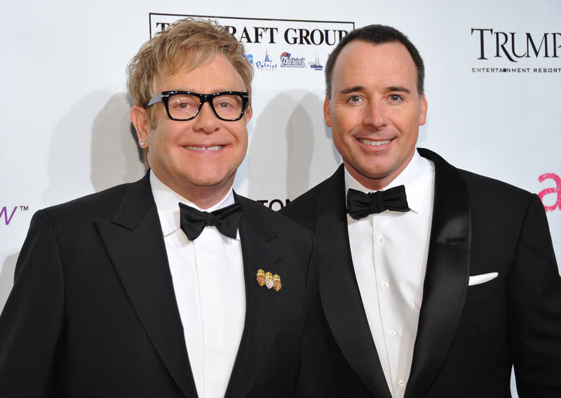 Sir Elton John, left, and partner David Furnish attend the Elton John AIDS Foundation benefit in New York on Oct. 18. John and Furnish have become parents of a 7-pound, 15-ounce baby boy born on Christmas Day in California.