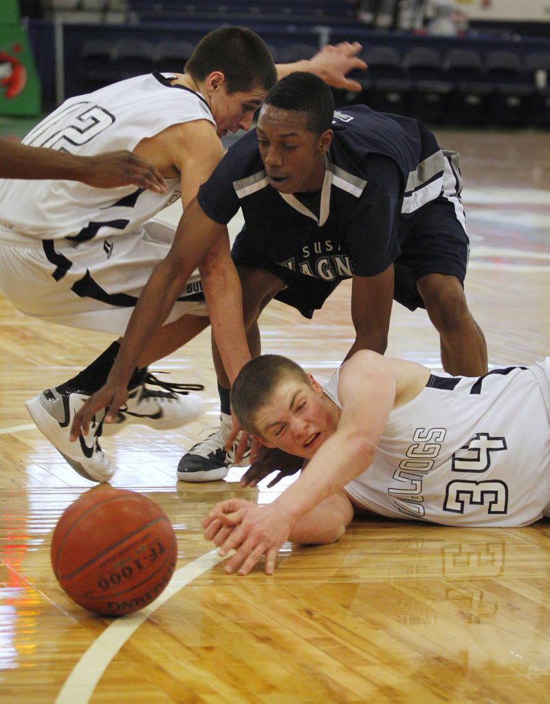 Matt McInnis, 34, and Justin Zukowski of Portland attempt to reach a loose ball ahead of Tyrese Campbell of Susan Wagner during Susan Wagner’s 55-44 victory at the Expo.