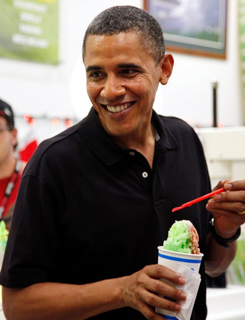 President Obama smiles Monday while enjoying shaved ice at Kailua Beach Center while on vacation.