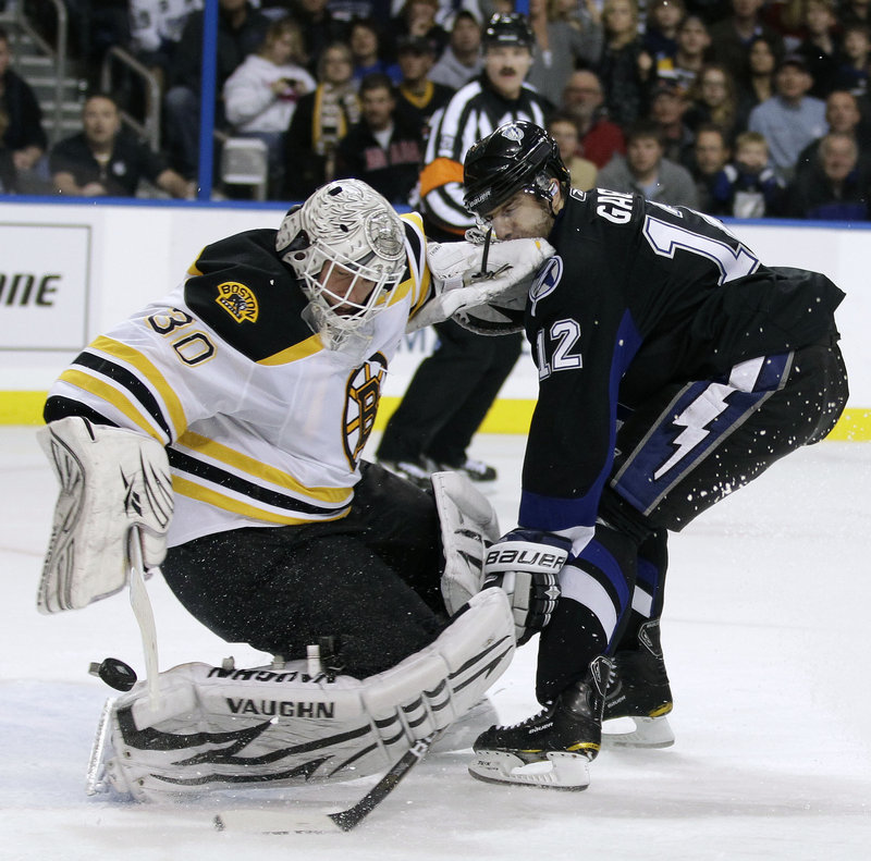 Bruins goalie Tim Thomas (31 saves) stops a shot by Tampa Bay’s Simon Gagne on Tuesday night in Tampa, Fla. Mark Recchi’s goal with 19.7 seconds left gave Boston a 4-3 win that pushed the Bruins into the Northeast Division lead, two points up on Montreal.