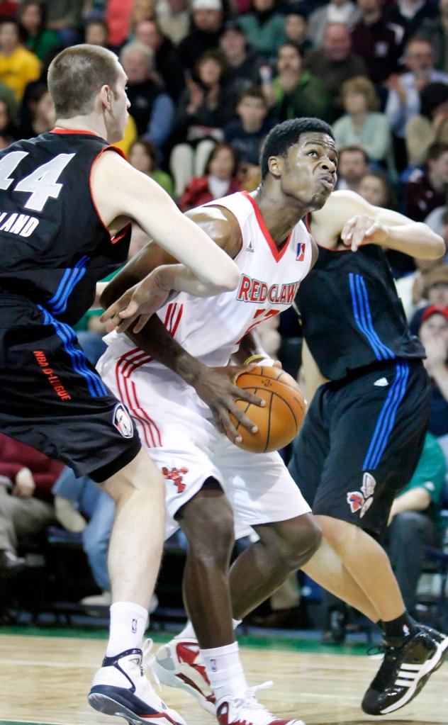 DeShawn Sims of the Maine Red Claws attempts to slip past Chas McFarland of the Springfield Armor during the Red Claws’ 114-103 victory Tuesday night at the Expo.