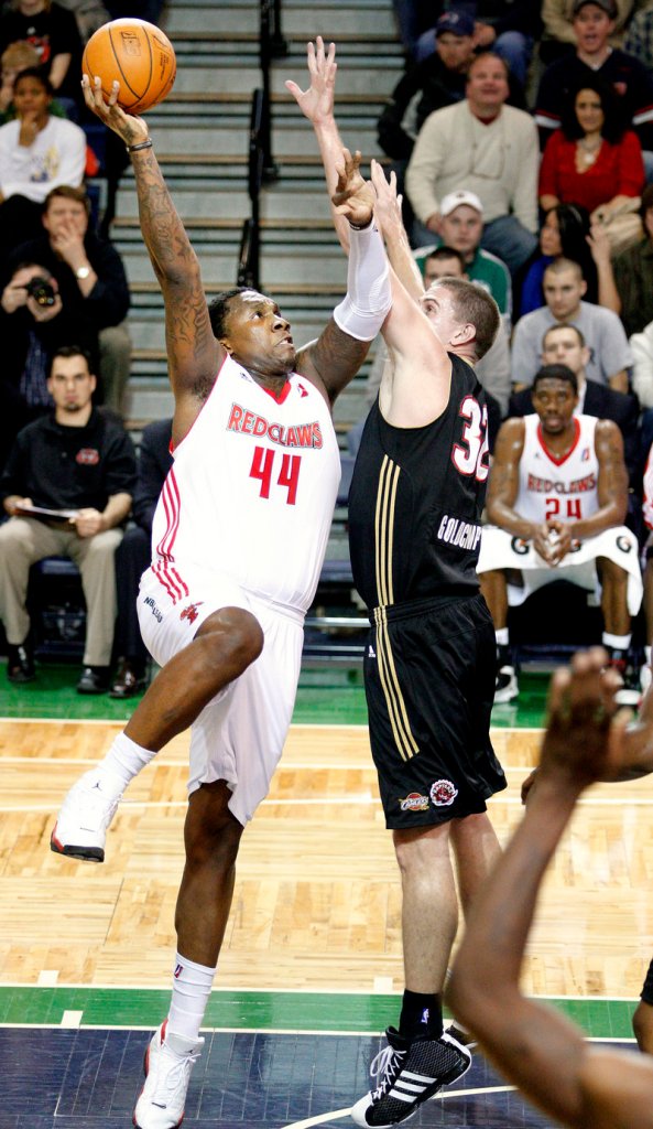 Tiny Gallon of the Maine Red Claws lifts a shot over Kyle Goldcamp of the Erie BayHawks during Maine s 120-107 victory Thursday night at the Portland Expo.