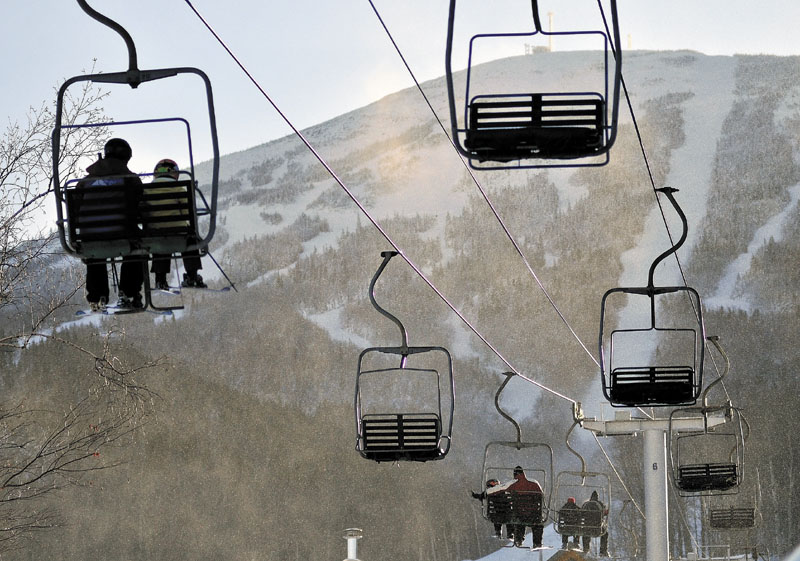 Skiers ride a chairlift at Sugarloaf. Another lift derailed on Dec. 28 in high winds, injuring eight people.