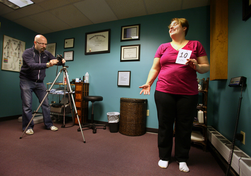 Denise Dyer of Biddeford competes in the weight loss challenge at Jacobs Chiropractic Center in Portland on Saturday. Dr. Lou Jacobs photographs Dyer for the before photos for the weight loss challenge.