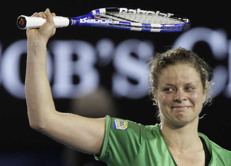 Kim Clijsters raises her arms as she celebrates her win over China's Li Na in the women's singles final at the Australian Open today.