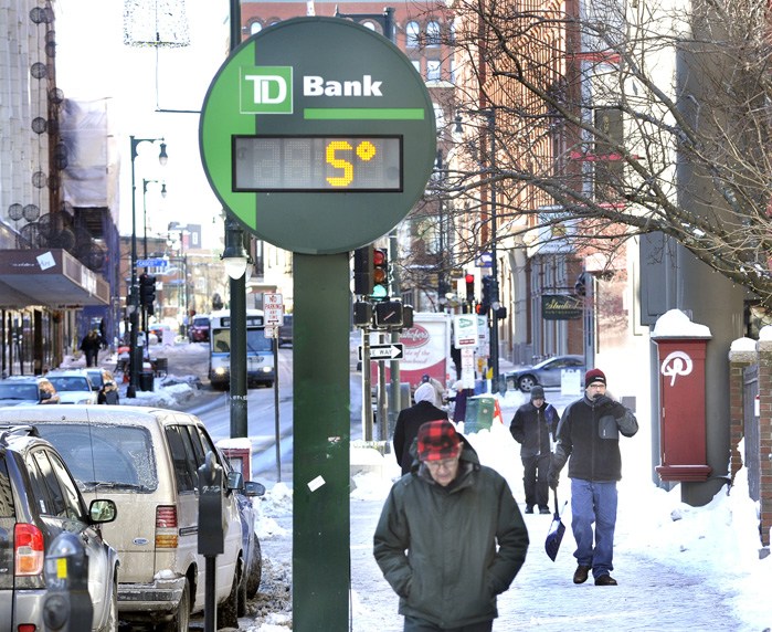 Portlanders brave the 5 degree sub-freezing temperature along Congress Street this morning.