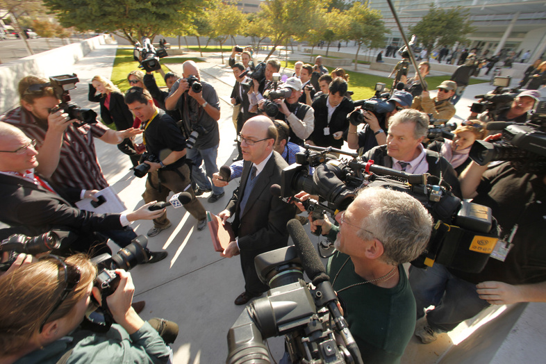 United States District Attorney Patrick Cunningham, center, talks to the press following the initial court appearance of Jared Loughner at the Sandra Day O'Connor United States Courthouse in Phoenix, Ariz., on Monday. Speculation that the rampage in Arizona that left six dead is tied to politics ignores evidence that Loughner is a disturbed individual who acted alone.