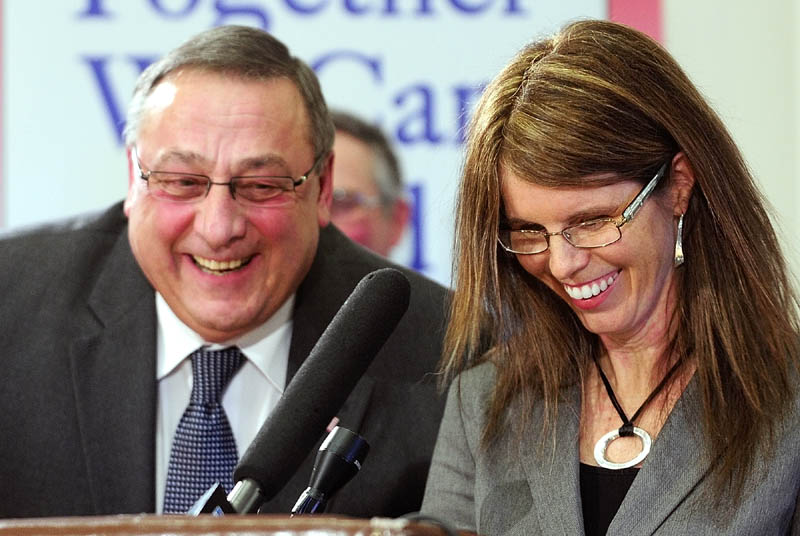 Gov. Paul LePage, left, and Mary Mayhew, his nominee for commissioner of the state Department of Health and Human Services, laugh during a press conference this morning in the State House's Cabinet room in Augusta.