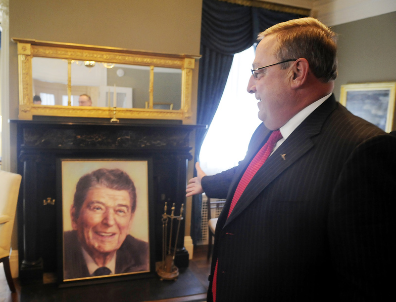 In the Blaine House on Wednesday, Gov. Paul LePage shows off a portrait of former President Ronald Reagan that he bought at the MardenÃ¢ s in Waterville for $64.