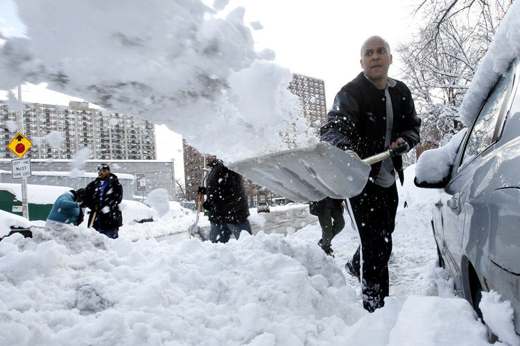 Newark Mayor Cory Booker shovels snow to dig out Jasmine Ingram's vehicle, in Newark, N.J. "It was very nice. I didn't expect it so it was shocking," said Ingram, 20, who was one of four people to have their vehicle dug out by the mayor and a group of residents.