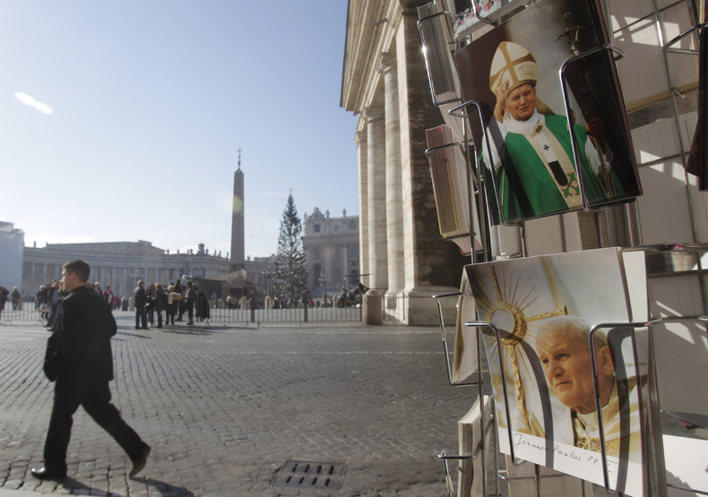 Postcards of the late Pope John Paul II are displayed outside a souvenir kiosk near St. Peter's Square in Rome on Friday. Pope Benedict XVI has approved a miracle attributed to John Paul II's intercession and set May 1 as the date for the beloved pontiff to be beatified.