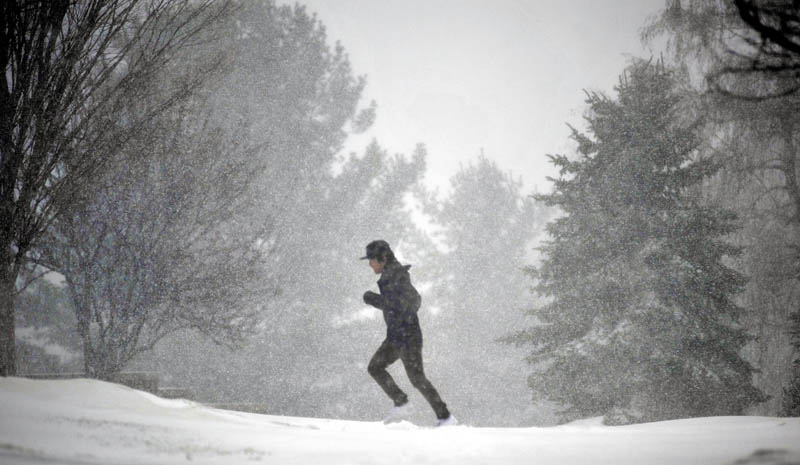 Staff photo by Michael G. Seamans A runner navigates his way through the heavy snow Wednesday morning at Colby College in Waterville.