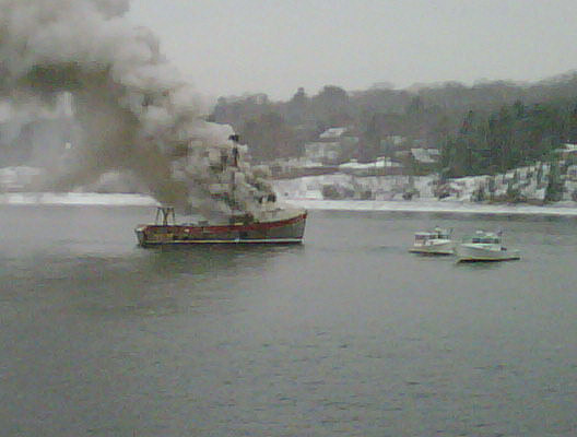 This photo taken by Gene Willard on his Blackberry shows the Debra Lee burning off the shore of Chebeague Island.