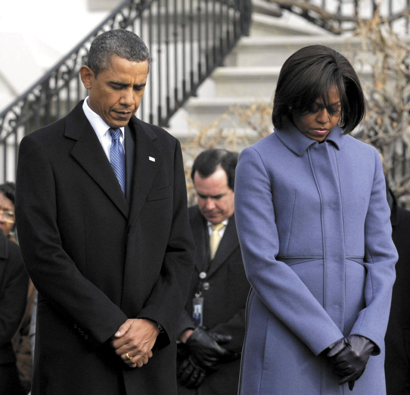 President Barack Obama, first lady Michelle Obama and government employees observe a moment of silence on the South Lawn of the White House in Washington on Monday to honor those who were killed and injured in the shooting Saturday in Tucson, Ariz. The injured include Rep. Gabrielle Giffords, D-Ariz., who was shot in the head.