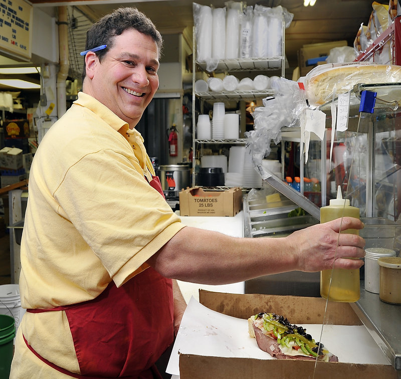 Sam DiPietro makes a roast beef Italian during lunch rush hour at DiPietro’s Market in South Portland.