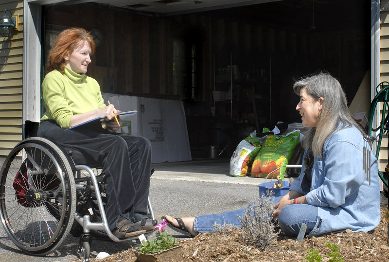 Kathy McInness-Misenor talks with Garden Angel volunteer Sue Tkacik at McInness-Misenor’s home in this photo from 2007. Garden Angels are Master Gardeners who help the disabled and elderly tend their gardens.