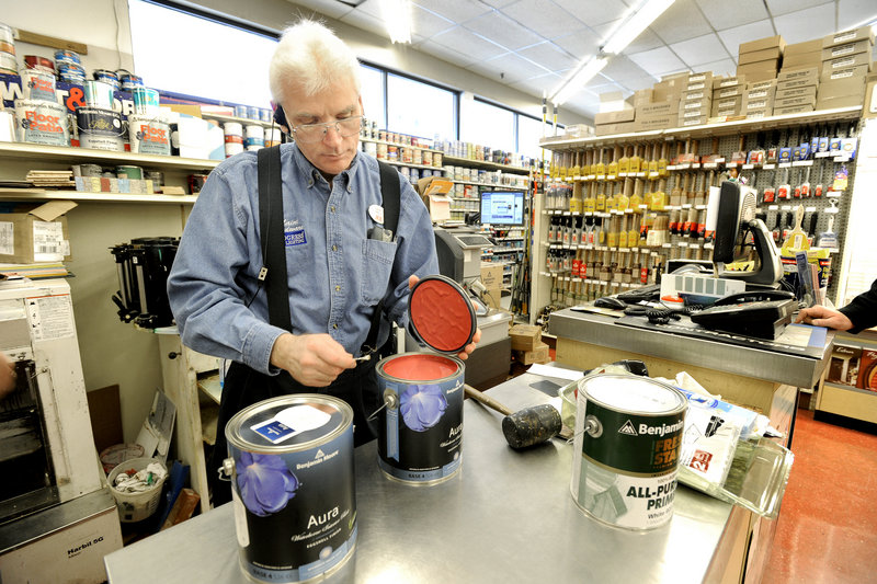Kevin Coolbrith checks the color after he mixes paint at Ace Maine Hardware store in Portland. Paint producers could be required to pay for collection and disposal of used cans if the Legislature acts on a recommendation.