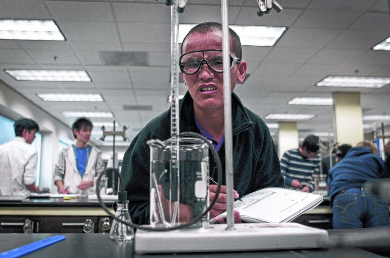 Tibetan monk Kunjo Baiji works through a chemistry experiment at Emory University in Atlanta. He is one of a group of monks sent by the Dalai Lama to the United States to learn science.