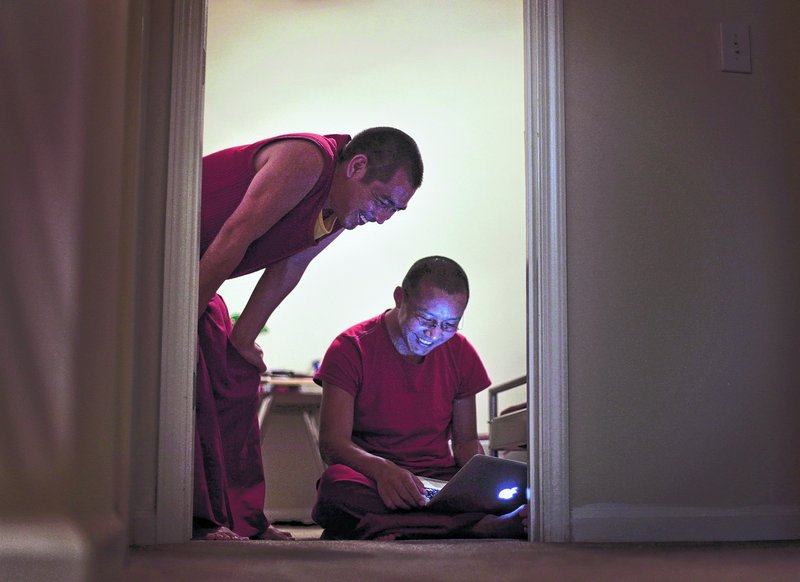 Lodoe Sangpo and Thabkhe Lo log onto Facebook at the off-campus apartment they share with four other monks in Atlanta.
