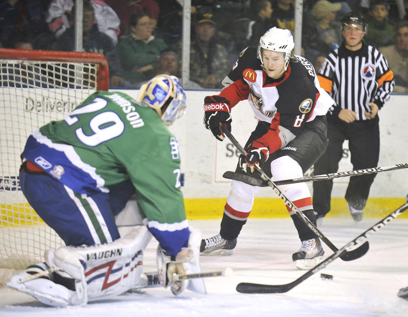 Chad Johnson, the goalie for the Connecticut Whale, keeps the near post covered Friday as Travis Persson of the Portland Pirates bears in during Connecticut s 5-4 overtime victory at the Cumberland County Civic Center.