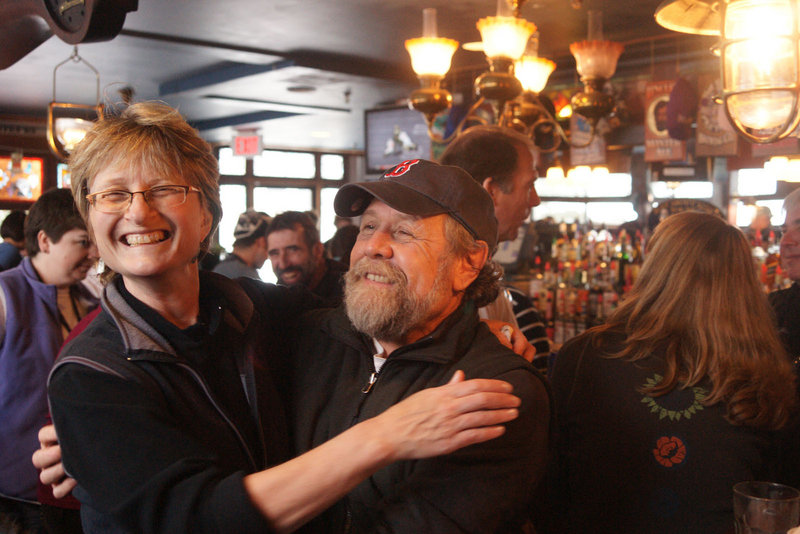 Anita Sebastian of Sherborn, Mass., hugs Steve Pierce, a Carrabassett Valley selectman, at the Bag & Kettle Brew Pub at the base of Sugarloaf. "We all know each other," she said.