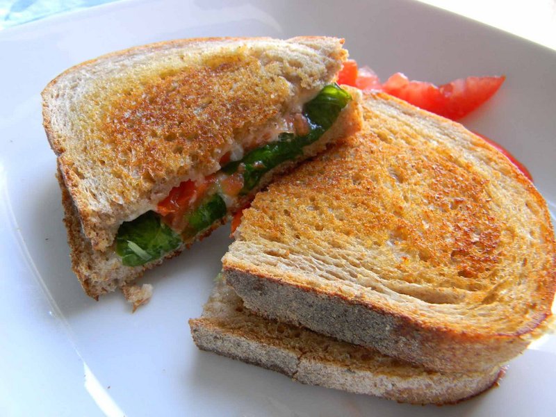 Grilled cheese sandwich with greenhouse-grown tomatoes and basil.