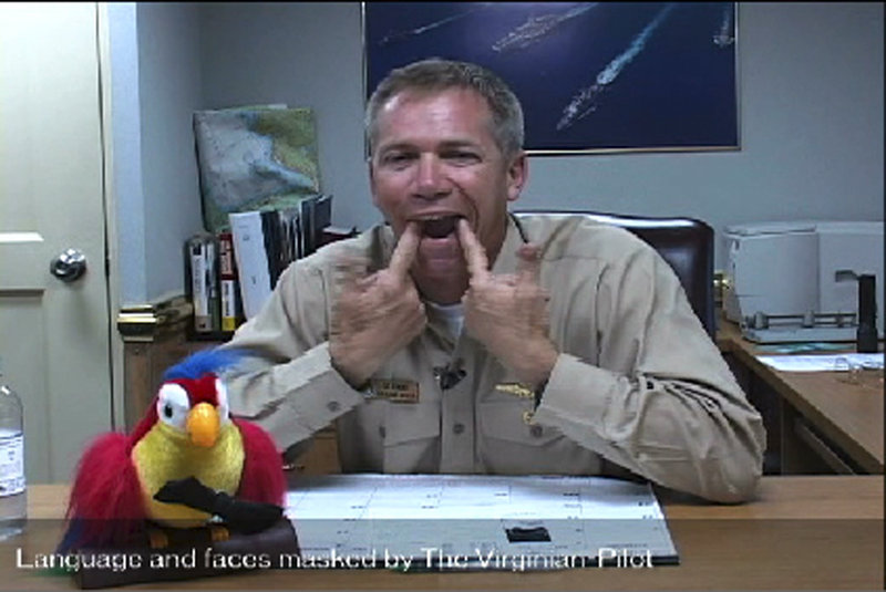 In this frame grab taken from video obtained by the Virginian-Pilot newspaper, Navy Capt. Owen Honors appears in one of a series of profanity-laced comedy sketches that were broadcast on the USS Enterprise via closed-circuit television. Honors, a top officer aboard a nuclear-powered aircraft carrier, broadcast to his crew the series of sketches in which he uses gay slurs, mimics masturbation and opens the shower curtain on women pretending to bathe together, a newspaper reported.