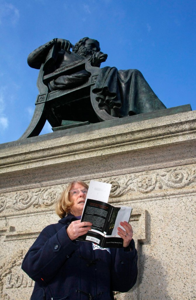 Elizabeth “Betsy” Sholl, Maine’s poet laureate, reads under the statue of Henry Wadsworth Longfellow on Wednesday in an event organized to celebrate poetry.