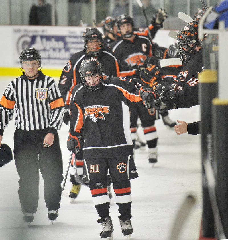 Brady Fleurent of Biddeford gets congratulations while skating in front of the bench after scoring his third goal of the game Wednesday night in the Tigers 5-1 victory over Thornton Academy at Biddeford Ice Arena.