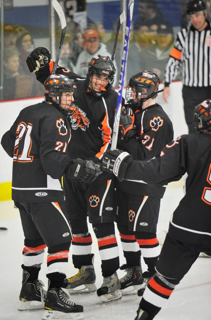 Bryan Dallaire, center, celebrates with Scott Callahan, left, and Brady Fleurent after scoring his second goal of the game for Biddeford in a 5-1 win over Thornton Academy.
