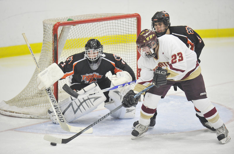 Seth Prior of Thornton Academy tries to collect a rebound in front of Biddeford goalie Jonathan Fields and Eric Grover. Fields had 20 saves for the win.