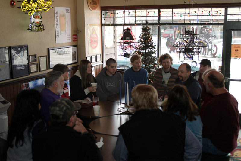 Chris Fletcher (with goatee), a seminary student, leads a Sunday morning session of "Bar Church" at Dunnigan's North Shore Pub & Grub in Two Harbors, Minn.