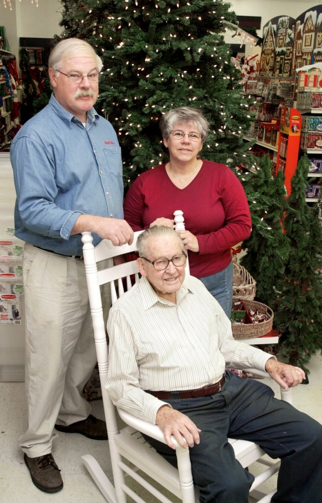 Tom and Maddie Simpson stand with Tom's father, Warren Simpson, at Shoppers True Value Hardware in South Portland in November 2003.