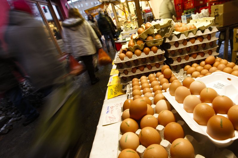People pass a stall with eggs at a farmers market in Berlin on Friday. German authorities have stopped more than 4,700 farms from selling poultry, pork and eggs as a precautionary measure against a growing scandal over animal feed contaminated with dioxin.