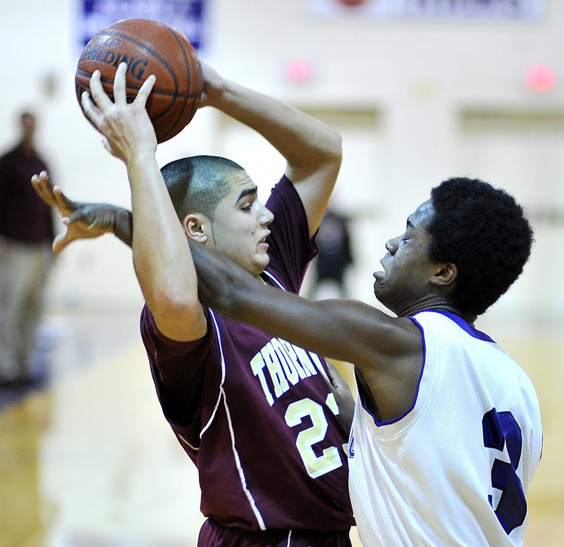 Thornton Academy’s James Ek, pressured here by Deering’s Riko Augustino, has recovered enough from a concussion to lead the SMAA in scoring at 20.5 points per game, with a league-best 27 3-pointers.