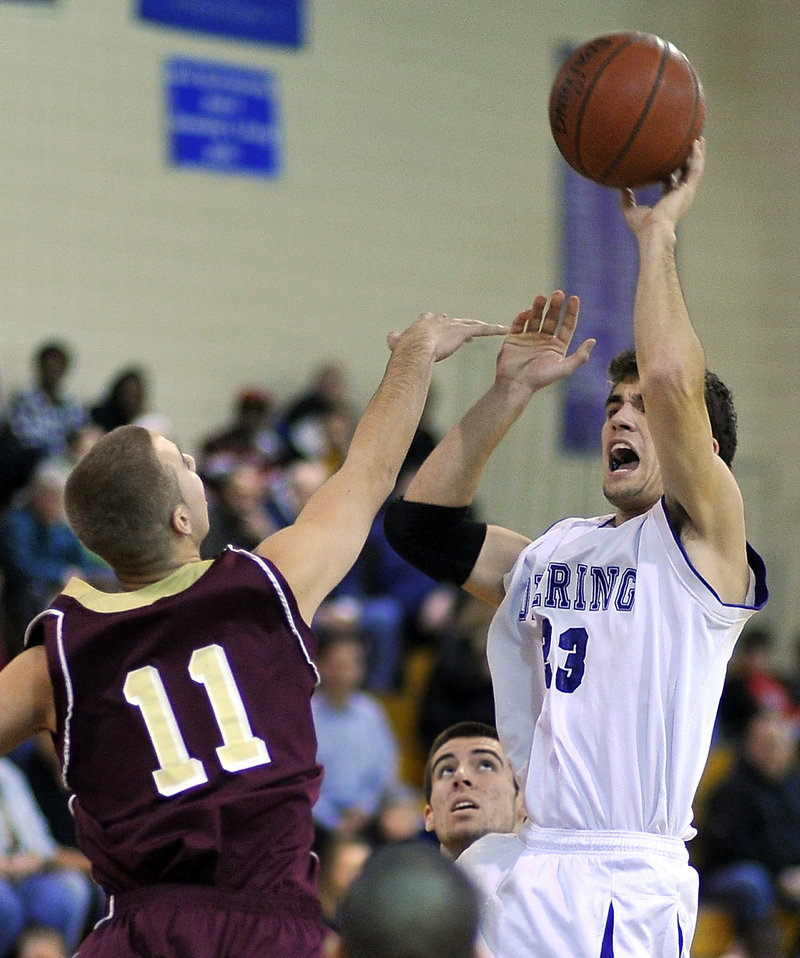 Nick Colucci of Deering lofts a 3-pointer over Justin Pollard of Thornton Academy in the first half. Deering improved to 4-2 and gave the Trojans their first loss.