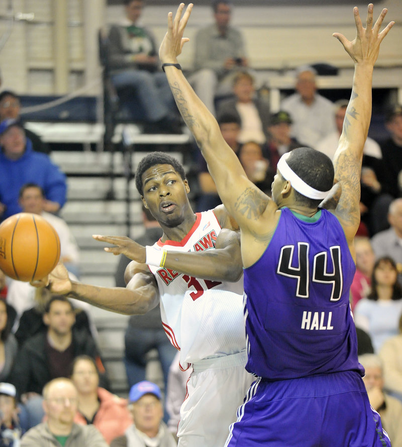DeShawn Sims of the Maine Red Claws looks to pass Friday night while guarded by Mike Hall of the Dakota Wizards at the Portland Expo.
