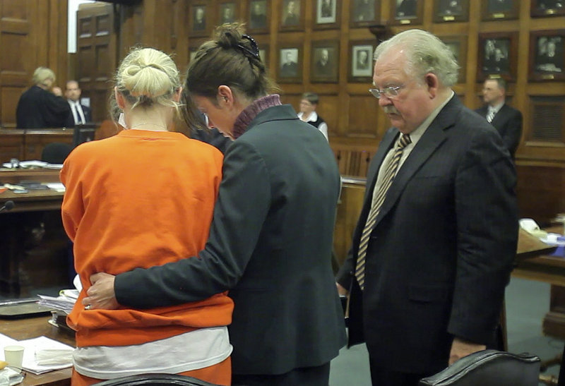 Attorneys Karen Wolfram, center, and Daniel Lilley, right, console Linda Dolloff after the sentencing on Friday.