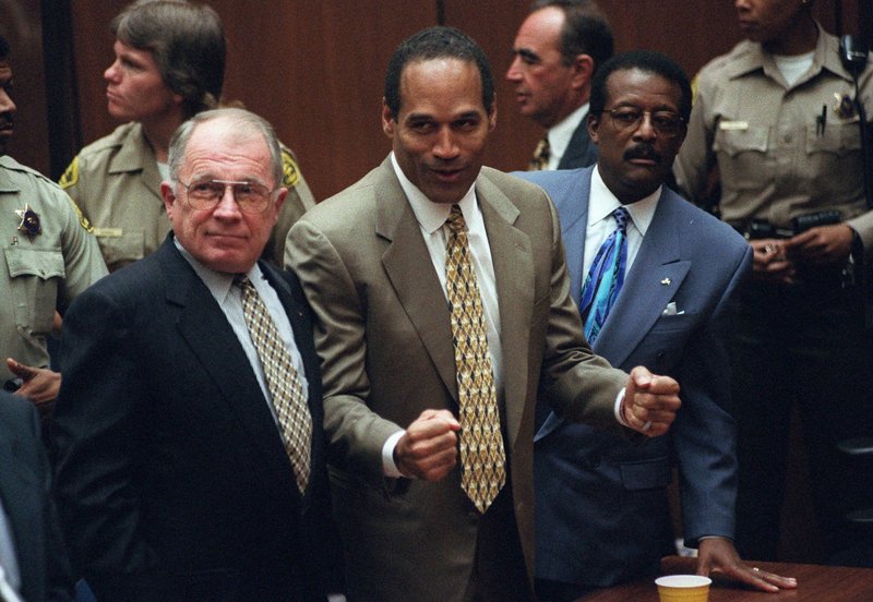O.J. Simpson reacts, Oct. 3, 1995, as he is found not guilty of murdering his ex-wife and her friend. Defense lawyers F. Lee Bailey, left, and Johnnie Cochran stand beside him. Bailey says there is a host of evidence proving Simpson’s innocence.