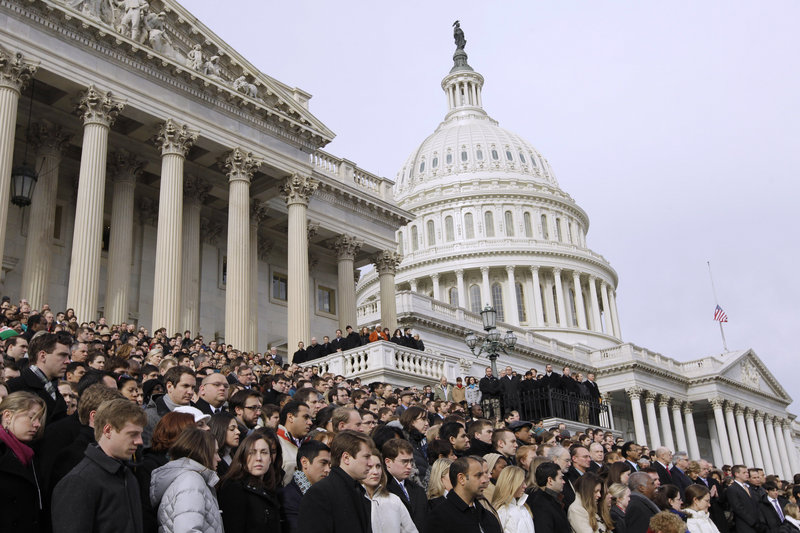 Members of Congress and their staffs observe a moment of silence for Rep. Gabrielle Giffords, D-Ariz., and other shooting victims Monday on the East Steps of the Capitol. Giffords, who was shot in the head at close range, remained hospitalized in critical condition.