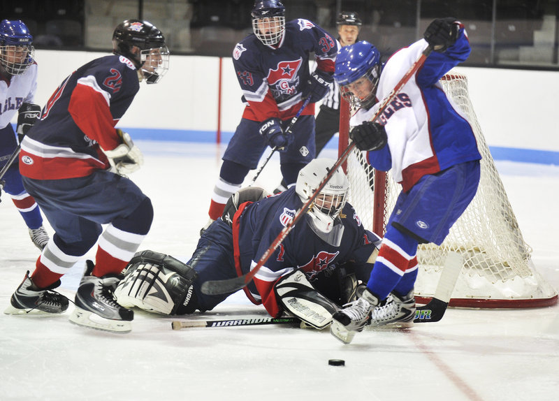 Justin Grant, right, of Mt. Ararat has a shot blocked by Gray-New Gloucester/Poland goalie Calvin Shelley. Grant scored a third-period goal, while Shelley finished with 16 saves to help the Patriotic Knights hold on for the victory.