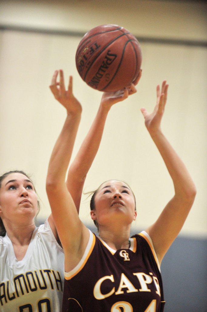 Nicole Rogers of Falmouth reaches from behind Cape Elizabeth’s Kisa Tabery to grab a rebound Tuesday night during Cape’s 31-25 schoolgirl basketball victory.