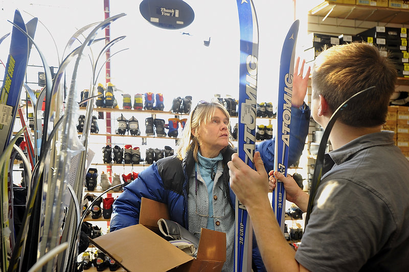 Nancy Krusell of Islesboro looks for a pair of cross-country skis Thursday at Play It Again Sports on Marginal Way, helped by assistant manager and salesman Nathan Leeman.
