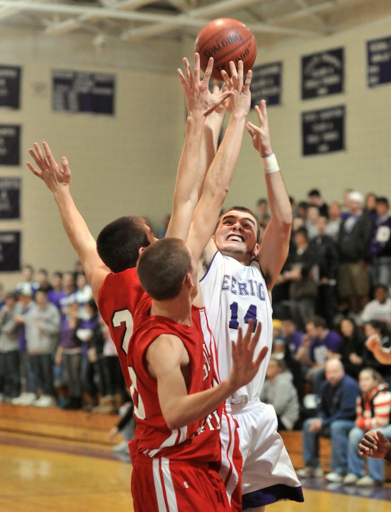 Jackson Frey of Deering lofts a shot over the South Portland defense during South Portland s 50-39 victory Thursday night. The Red Riots improved to 8-1 at the halfway stage of the season.